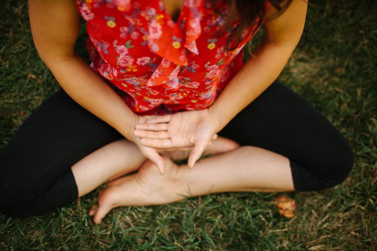 woman holding hands in sacral mudra